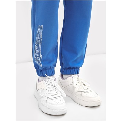 Хлопковые брюки для девочек в синем цвете с принтом
